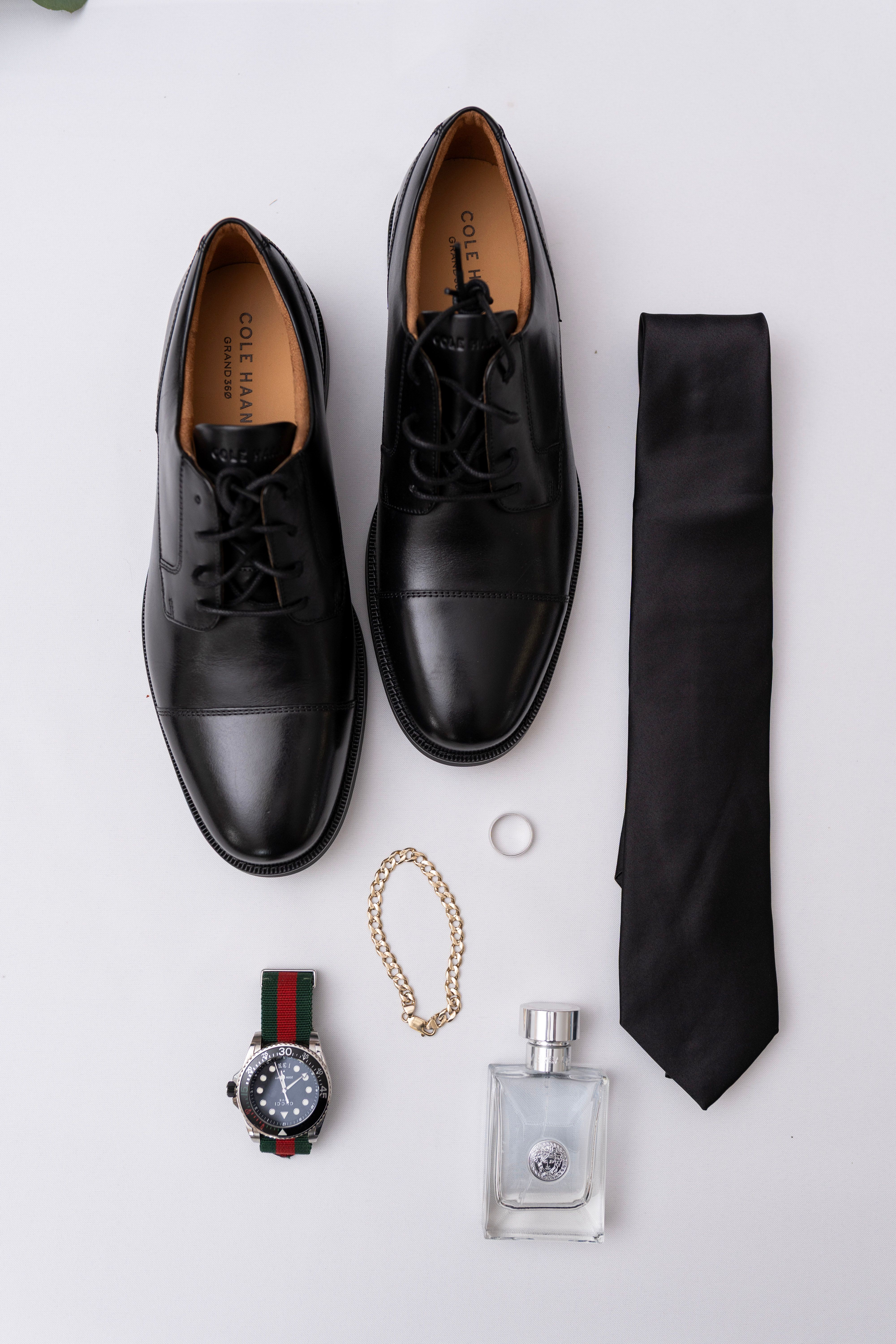 Bright formal-event flat lay featuring shoes, accessories, and floral details.